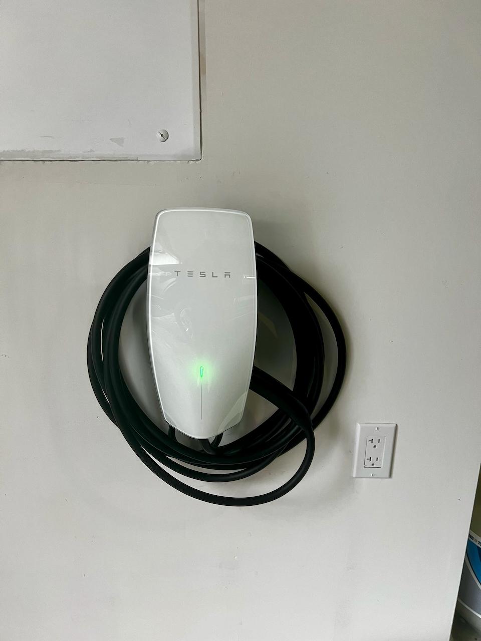 Tesla Wall Connector mounted on an interior wall